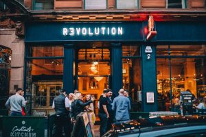 Exterior of Revolution Bar with customers outside